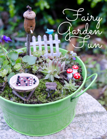 Picture of a planting pot with fairy garden elements inside.