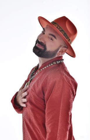 A picture of Ash Ruiz in a red shirt and red hat smiling at the camera
