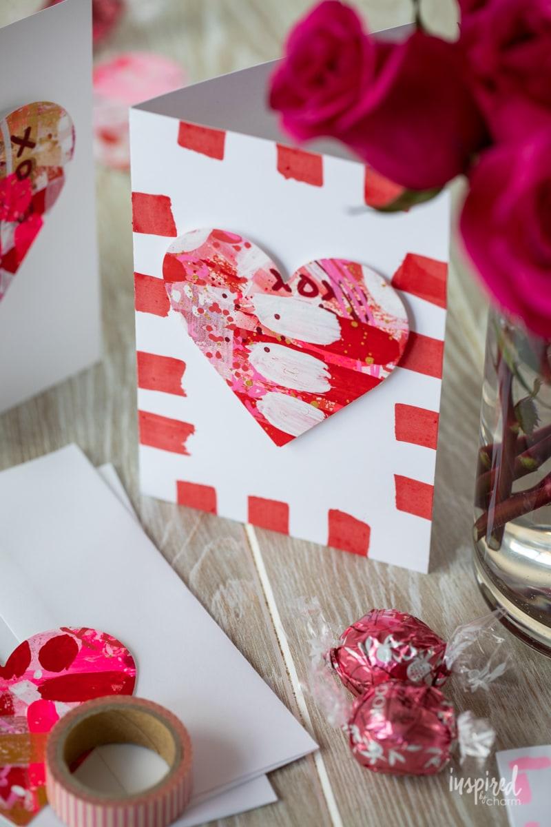 A homemade Valentine's Day card with a heart in the center in red, pink, and white colors